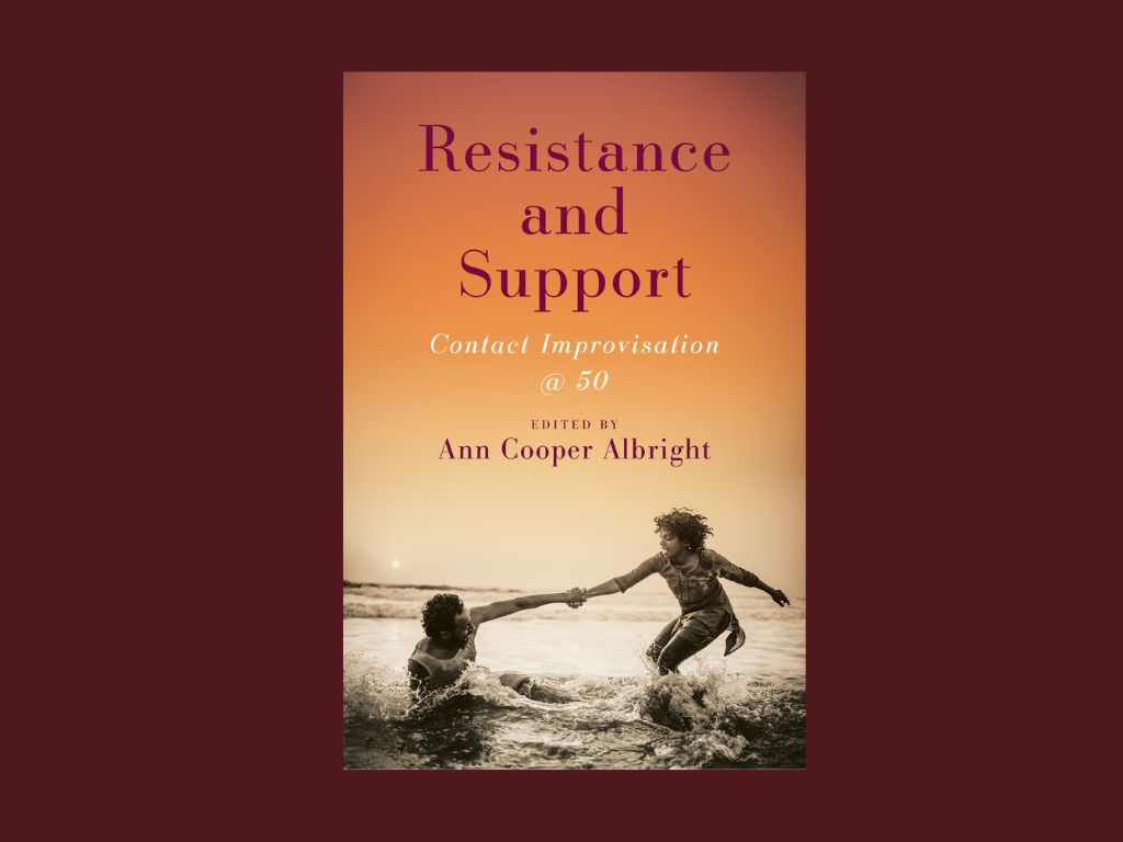 A flat image of the front cover of "Resistance and Support: CI @ 50" appears centered on a dark maroon background. From top to bottom, the cover descends through sunset – muted burnt orange, carrot, creamsicle, golden rod, pale yellow, into a black and white photo of two dancers partnering in the ocean. One dancer is on his ass in the water. The other stands, both knees bent, reaching out for her comrade in the waves. They hold hands at the wrists, arms fully extended. The title “Resistance and Support,” each word on its own line, spans the top third of the cover page in a burgundy, serif font. Below, the subtitle “CI @ 50” slants in smaller white italics. The text “EDITED BY: Ann Cooper Albright,” back to the burgundy with no italics, sits about one thumbs width above the dancers in the ocean.