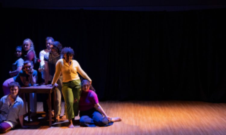 Laila Franklin (director and choreographer), Michael Figueroa, Jenna Gross, Marissa Molinar, Andrea Muñiz, Sarah Pacheco, Sasha Peterson, and Marcel Santiago Marcelino stand clustered together on stage.
