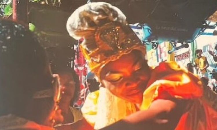 a book cover with a photo of Jennysalt, a rumbera interviewed and integral to the text, dancing in a Rumba ceremony, her head bowed to the left as her arm is lifting her skirt, cradling her head. her gaze is tilted downward, a calm expression resting on her face.